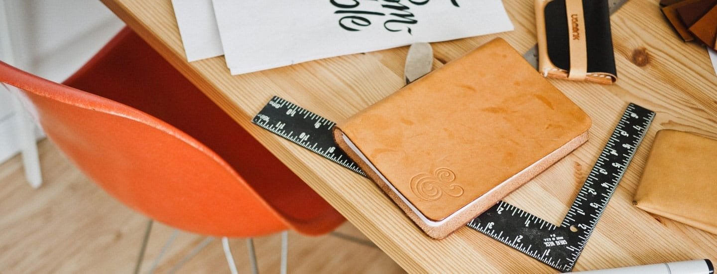 A desk with ruler and a book on it